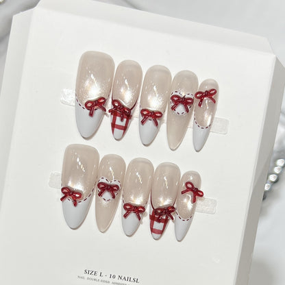 Dekorativer Stiletto Press-On Nagelset mit Schleifenakzenten Brehn