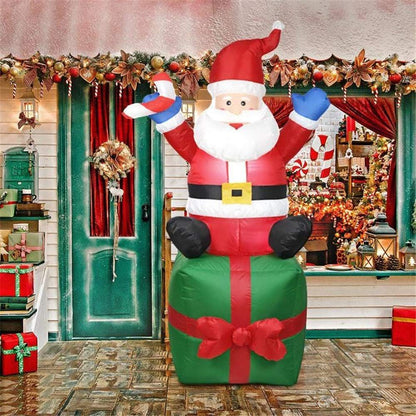 Aufblasbare Weihnachtsmann-Dekorationsfigur auf Geschenkpaket