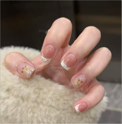 Kunstvolle Nagelkunst mit Glitzer- und Blumenapplikationen Brehn