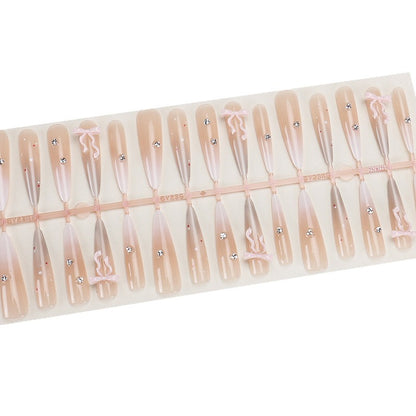 Elegante Stiletto Press-On Nägel mit dekorativem Bogen und Strassakzenten Brehn