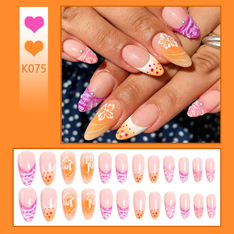 Kunstnagelset mit exotischen Blumenmustern und Glitzerakzenten Brehn
