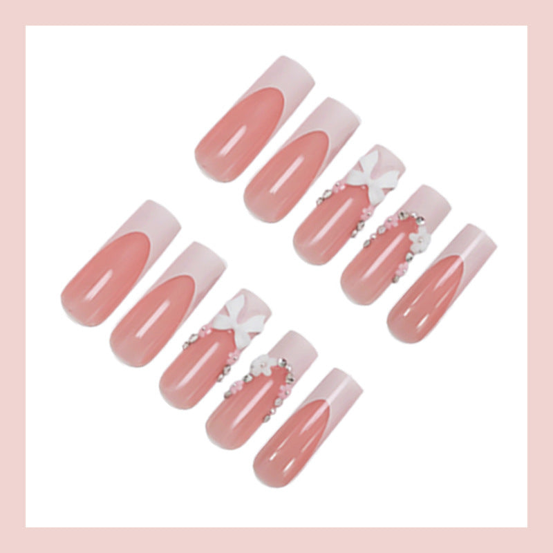 Kunstnagelset mit eleganten Schleifen und Glitzerakzenten Brehn