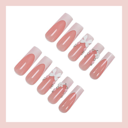 Kunstnagelset mit eleganten Schleifen und Glitzerakzenten Brehn