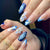 Kunstnagelset mit handgefertigten blumigen Motiven und elegantem Glitzer Brehn