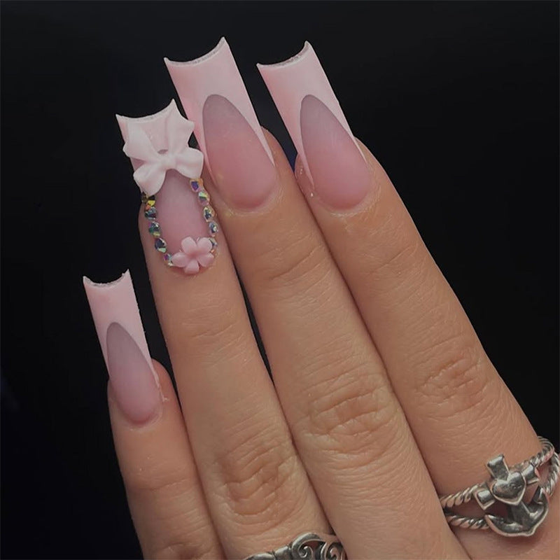 Dekorative Press-On Nagelkunst mit floralen und Schleifenakzenten Brehn