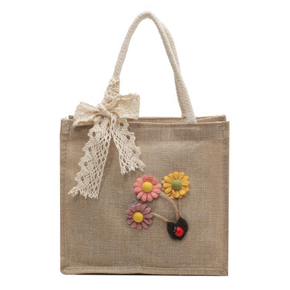 Blumennietete Jute-Handtasche