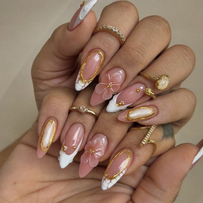 Kunstvolle Nagelkunst mit floralen und goldenen Akzenten Brehn