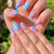 Kunstnagelset mit floralen und karierter Gestaltung Brehn