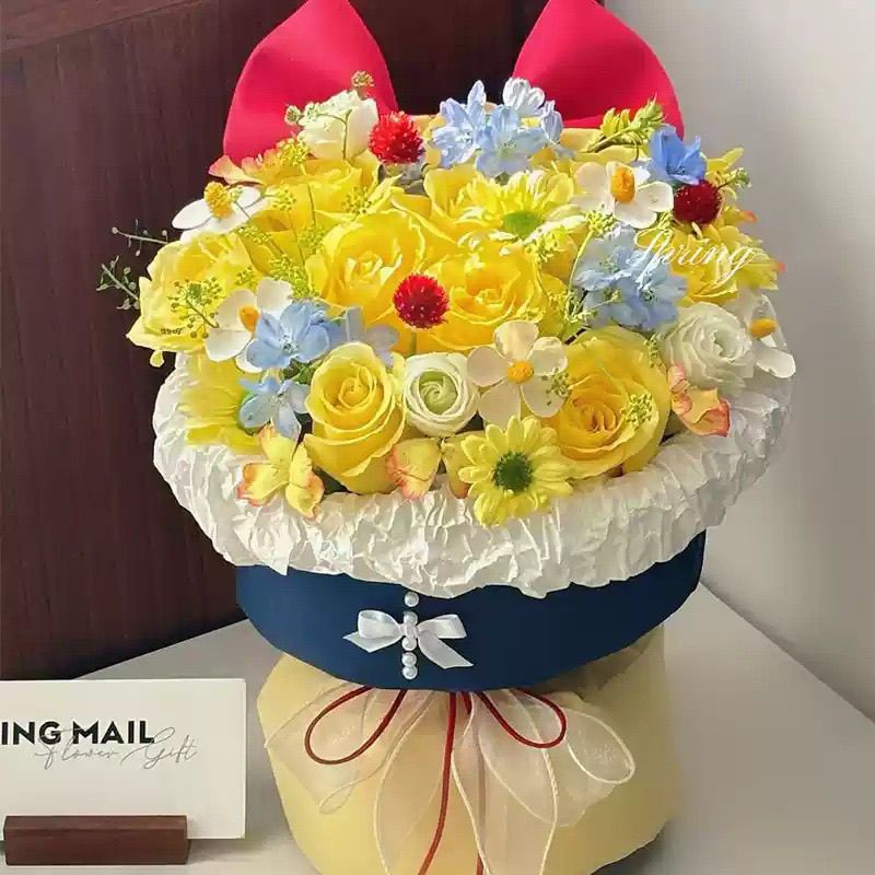 Künstliches Blumenarrangement mit Schleifenakzent
