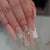 Elegante Lange Press-On Nagelset mit Dekorativen Edelsteinen und Blumenakzenten Brehn