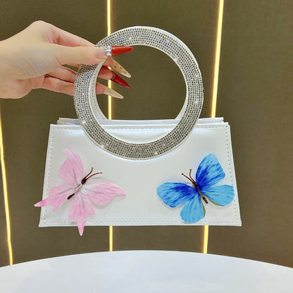 Künstlerische mit Schmetterlingen verzierte Handtasche