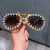 Damen Sonnenbrille im futuristischen Design mit spitzen Kristallverzierungen Brehn