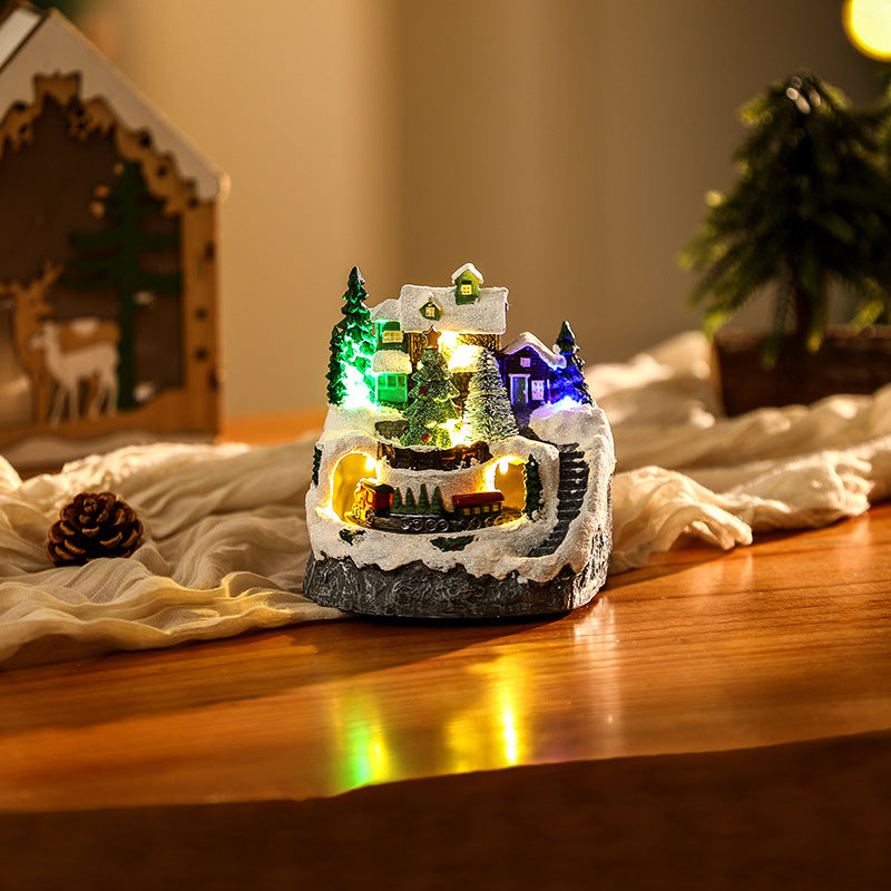 Beleuchtete Weihnachtsdorf-Szene mit Schneemann Brehn