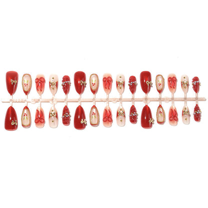 Kunstnagelset mit festlichen Designs und Glitzerelementen Brehn
