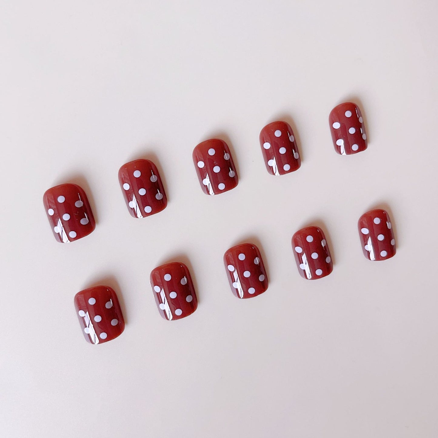 Kunstnagelset mit stilvollen Schokoladenflecken und eleganten Punkten Brehn