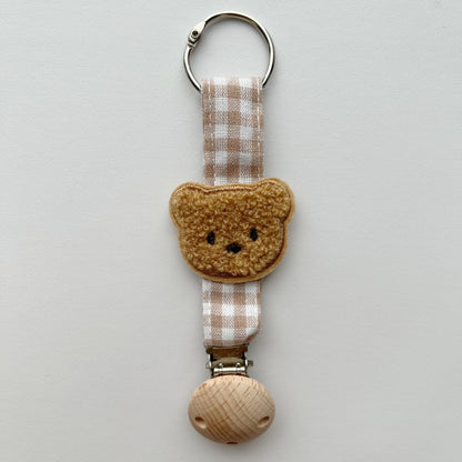 Handgefertigter Holz-Clip Schnullerhalter mit Gingham-Gurt und gepolstertem Blumenbeißring