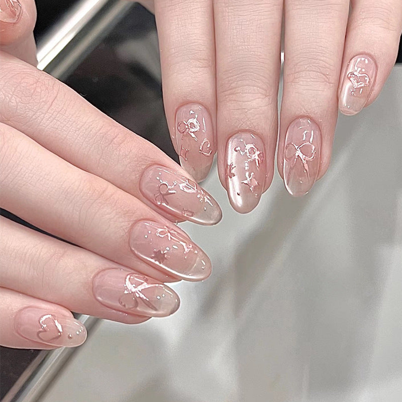 Elegante künstlerische Press-On-Nagelkunst mit Schleifen- und Herzdesigns Brehn