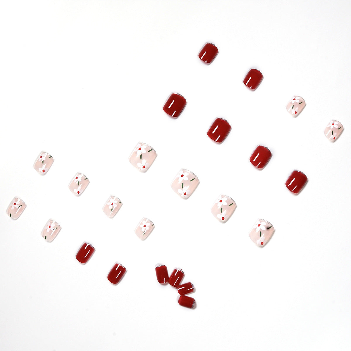 Kunstvolle Nagelkunst mit floralen Motiven und Glitzerakzenten Brehn