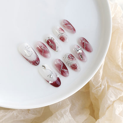 Künstlerisches Press-On-Nagelset mit floralen Designs und Steindekoren