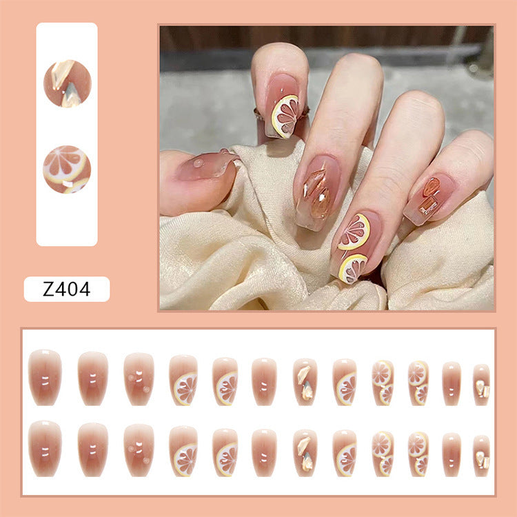 Kunstnagelset mit fröhlichen Zitrusmotiven und eleganten Designs Brehn