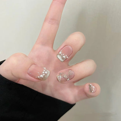 Elegante Kunstnägel mit Perlenschmuck und Glitzereffekten Brehn