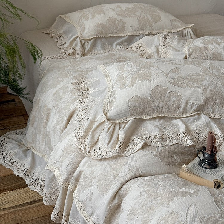 Vintage-inspirierte Baumwoll-Leinen Bettgarnitur mit großfloraler Musterung, Volant und Spitzenapplikation