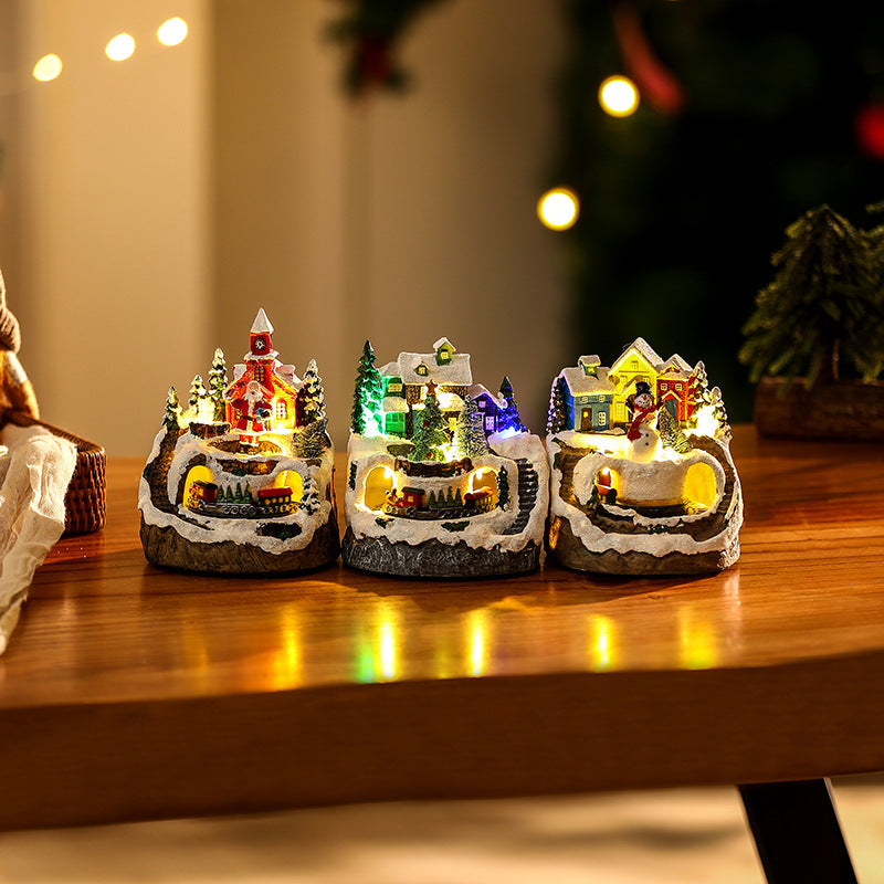 Beleuchtete Weihnachtsdorf-Szene mit Schneemann Brehn