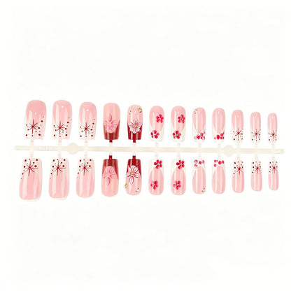 Kunstnagelset mit floralen 3D-Details und Glitzerakzenten Brehn
