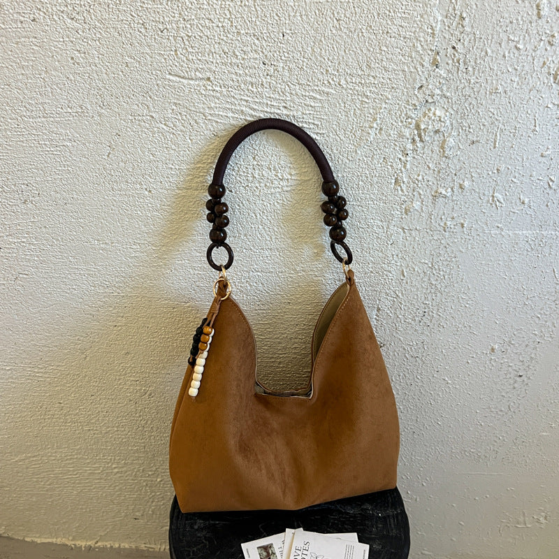 Stylische Hobo-Handtasche mit Perlenriemen
