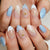 Kunstnagelset mit glitzernden Akzenten und floralem Design Brehn