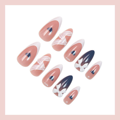 Kunstnagelset mit eleganten Schleifen und herzförmigen Akzenten Brehn