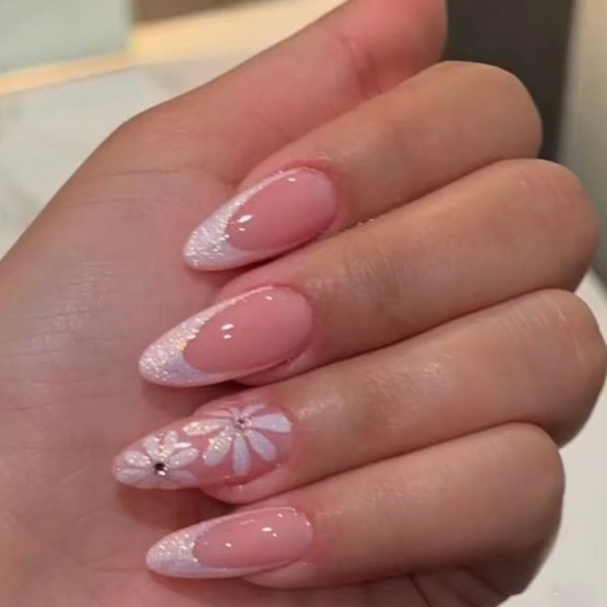 Elegante Kunstnägel mit floralem Design und Glitzerverzierungen Brehn