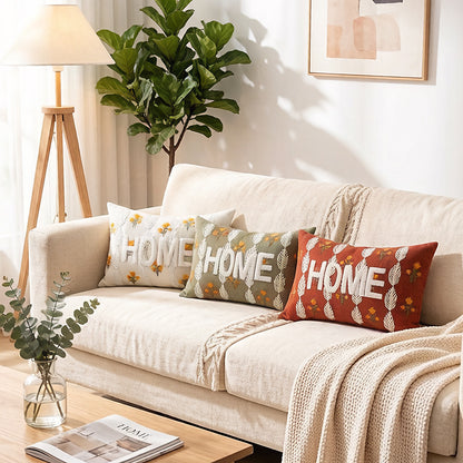 Besticktes strukturiertes Lendenkissen mit HOME-Buchstaben und Blattmotiv