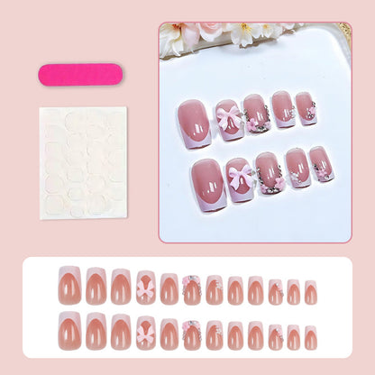 Kunstnagelset mit verspielten Schleifen und eleganten Blütenverzierungen Brehn