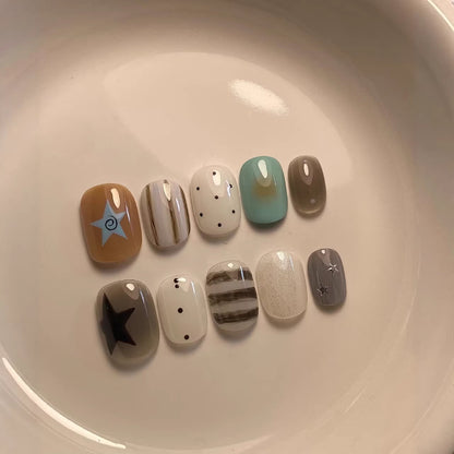 Künstlerisches Press-On Nagelset mit geometrischen und Stern-Designs
