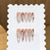 Kunstnagelspitzen mit Kreuz- und Glitzermotiven Brehn