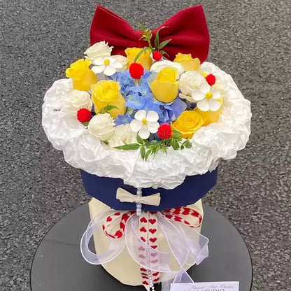 Künstliches Blumenarrangement mit Schleifenakzent