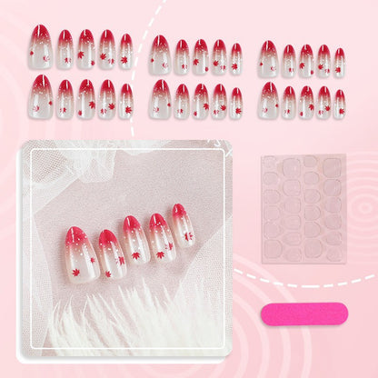 Kunstnagelset mit elegantem Rot-Ombré-Look und zarten Ahornblättern Brehn