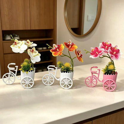 Dekorativer Fahrrad-Blumentopf mit Kunstorchideen-Arrangements für Dekor