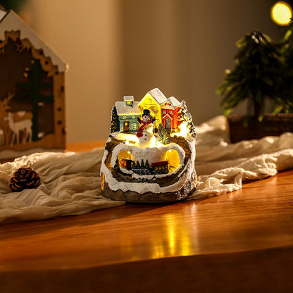 Beleuchtete Weihnachtsdorf-Szene mit Schneemann Brehn