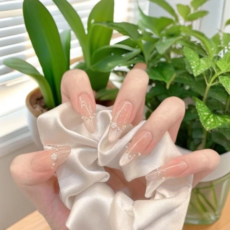 Dekorative Acryl-Nagelerweiterungen mit perlmuttartigen Akzenten