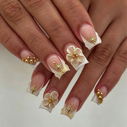 Kunstnagelset mit zarten Blüten- und Goldverzierungen Brehn