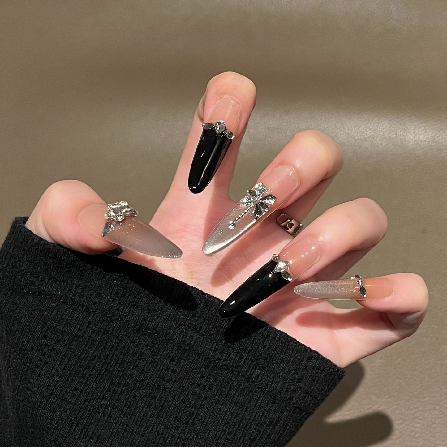 Künstlerische Stiletto Press-On Nagelkunst mit schimmernden Akzenten Brehn