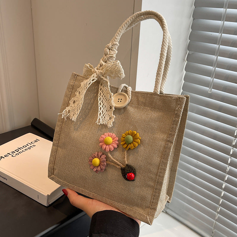 Blumennietete Jute-Handtasche
