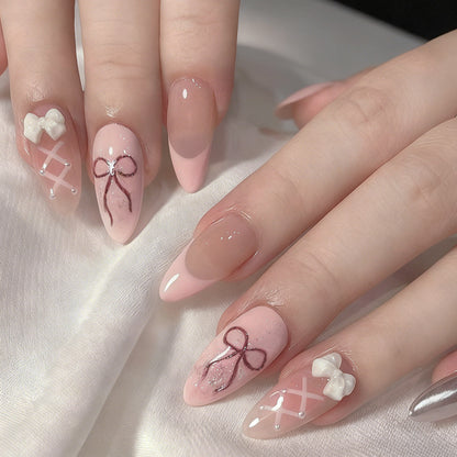 Kunstnagelset mit romantischen Schleifen- und Blumenverzierungen Brehn