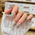 Dekorativer Press-On-Nagelkunst-Set mit funkelnden Strass-Akzenten Brehn