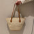Elegante Geflochtene Tasche mit Ledergriffen Brehn