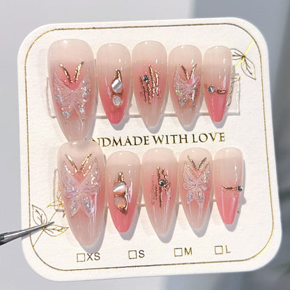 Künstliche Nagelverlängerungen mit floralen Motiven und Glitzerakzenten Brehn