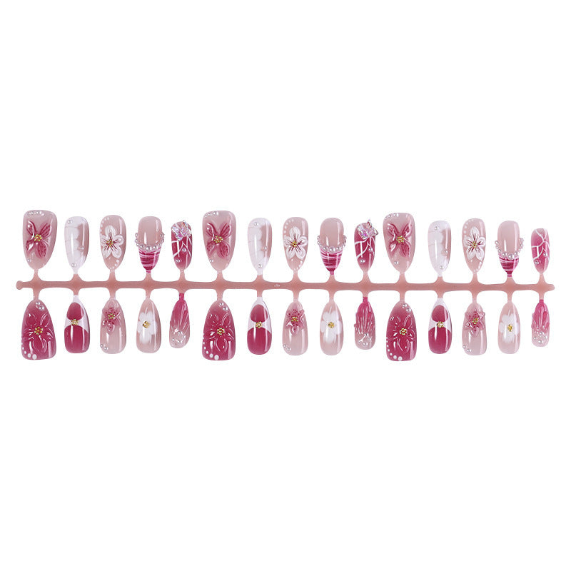 Kreatives Kunstnagelset mit floralen Akzenten und Glitzerverzierungen Brehn