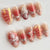 Kreatives Kunstnagelset mit eleganten Blumendesigns und Glitzerakzenten Brehn